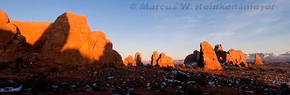 Monoliths aglow in final evening sunlight, viewed from the North Window, Arches National Park, Utah.
