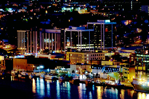 Viewed from Signal Hill, city lights and building reflections on the waterfront at Saint John's, Newfoundland, Canada.