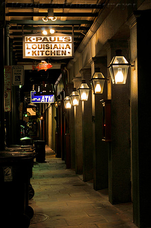 New Orleans night scene, with signs for k-Paul's Louisiana Kitchen and ATM machine.