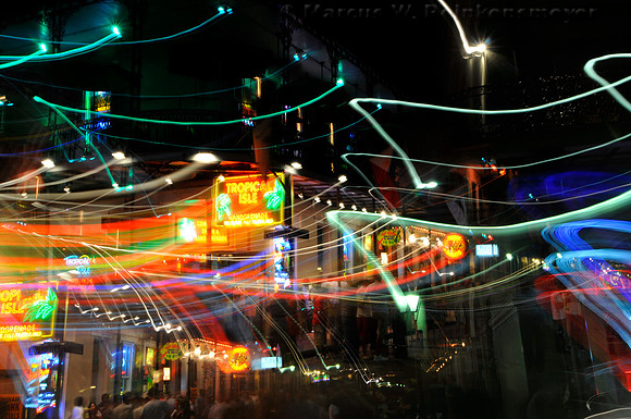 Time exposure of neon lights and party goers at Tropical Isle on Bourbon Street, New Orleans, Louisiana.