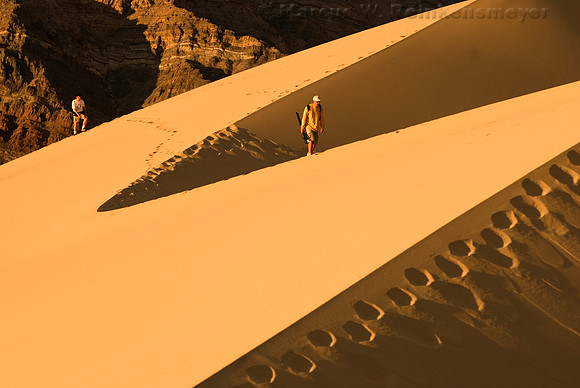 Dune trekkers hiking to the summit of the Eureka Dunes at Death Valley National Park.