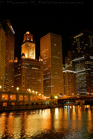 Night scene of world class architecture, with golden reflections on the Chicago River.