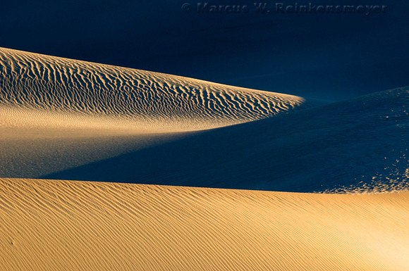 Warm sunlight and long shadows create abstract images at the Mesquite Flat Dunes in Death Valley National Park, California.
