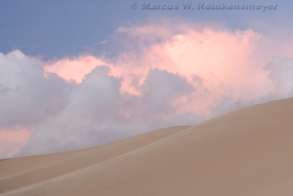Pink sunset amidst a sandstorm at Eureka Dunes, Death Valley National Park, California
