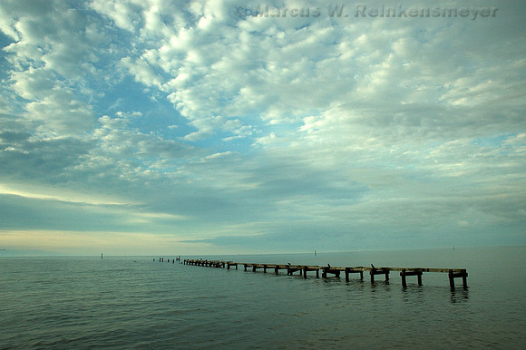 Weathered wooden structure under heavenly skies, before Hurricane Katrina ravaged the Gulf Coast. Biloxi, Mississippi.