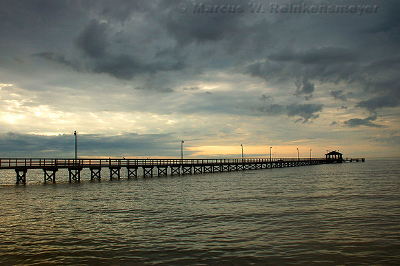 Ominous skies at a pier located on the Gulf Coast, Biloxi, Mississippi.