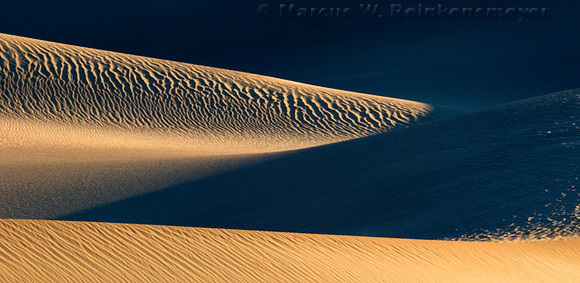 Warm sunlight and long shadows create abstract images at the Mesquite Flat Dunes in Death Valley National Park, California.