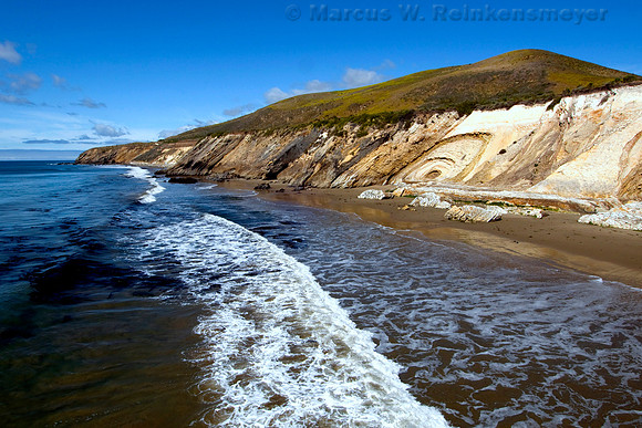 Pristine Pacific coastline shoreline viewed from the wooden pier at Gaviato State Park, California.