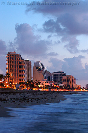 Sandy shore and hotels on the Fort Lauderdale coastline at dawn.
