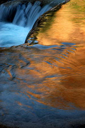 Golden canyon wall reflections at Havasu Falls in Havasupai Falls, a side canyon of the Grand Canyon, Arizona.