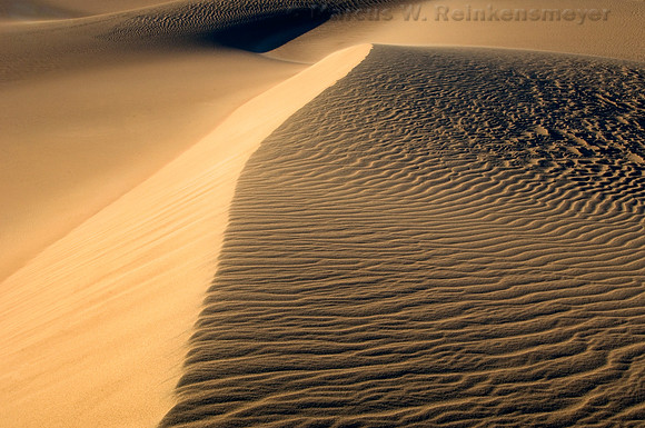 Warm sunlight and long shadows create abstract images at the Mesquite Flat Dunes in Death Valley National Park, California.